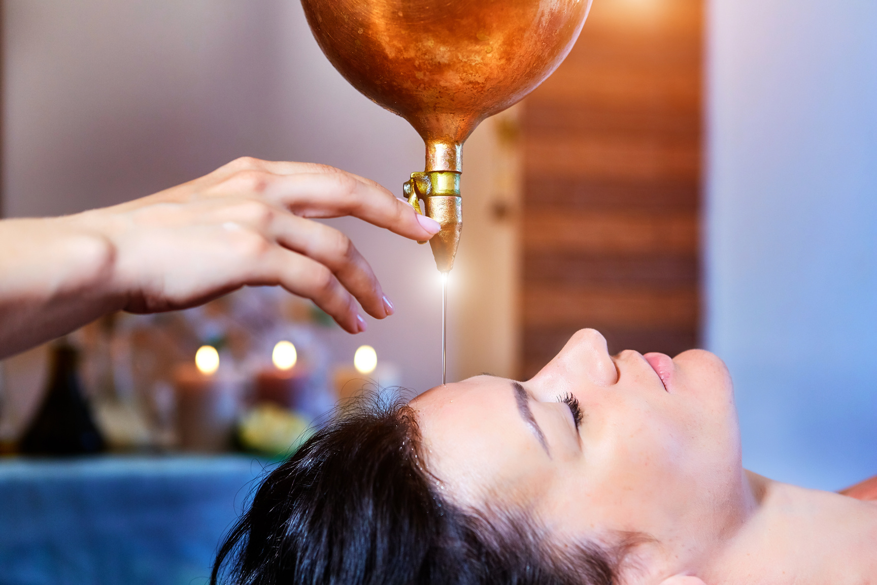 Woman enjoying a Ayurveda oil massage treatment in a spa